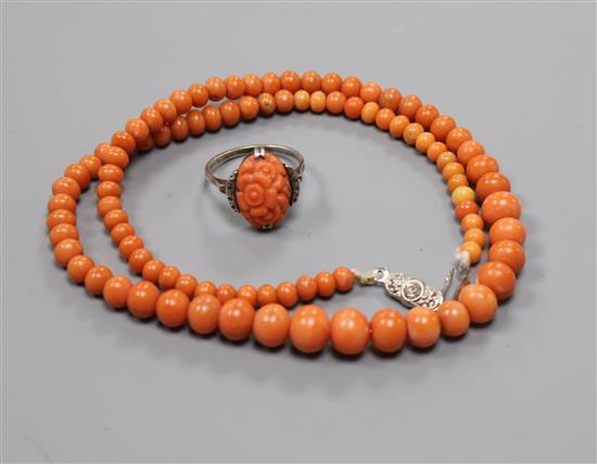 A single strand graduated coral bead necklace and a carved coral ring.